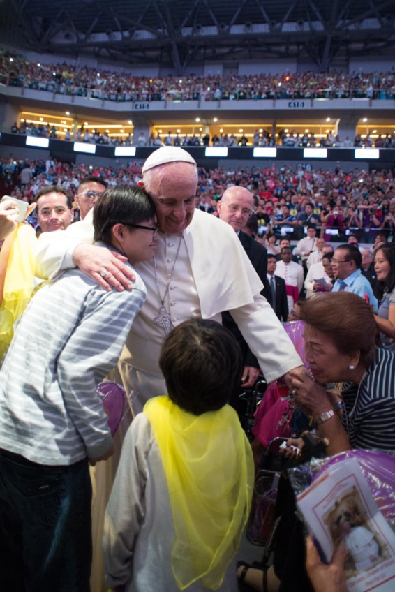 Pope Francis is greeted during a meeting with Filipino families in Manila